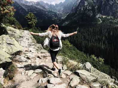 A woman hiking along a mountainous trail